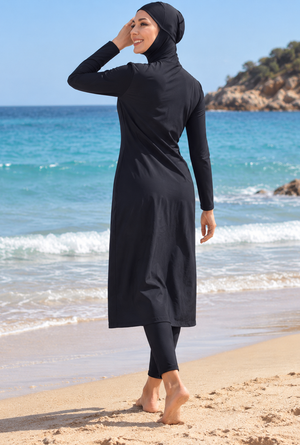 Back view of women's black full-coverage modest swimwear with hijab, long tunic and leggings