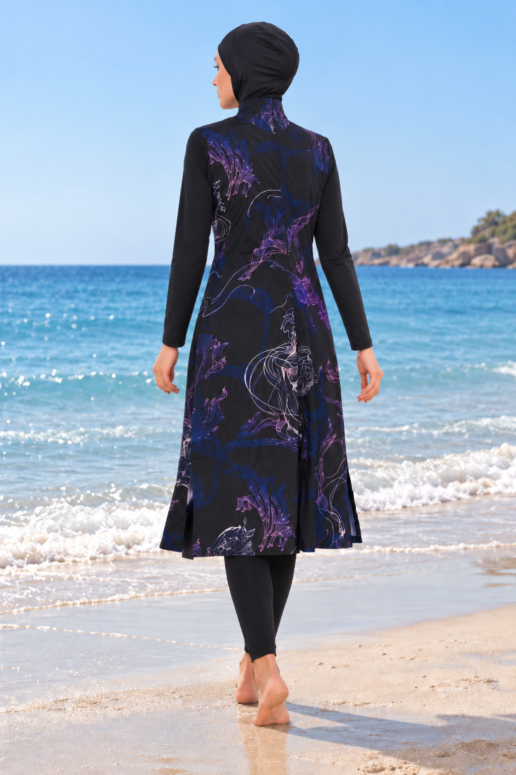 Back view of women's navy floral full-coverage modest swimwear with hijab, long tunic and leggings on beach
