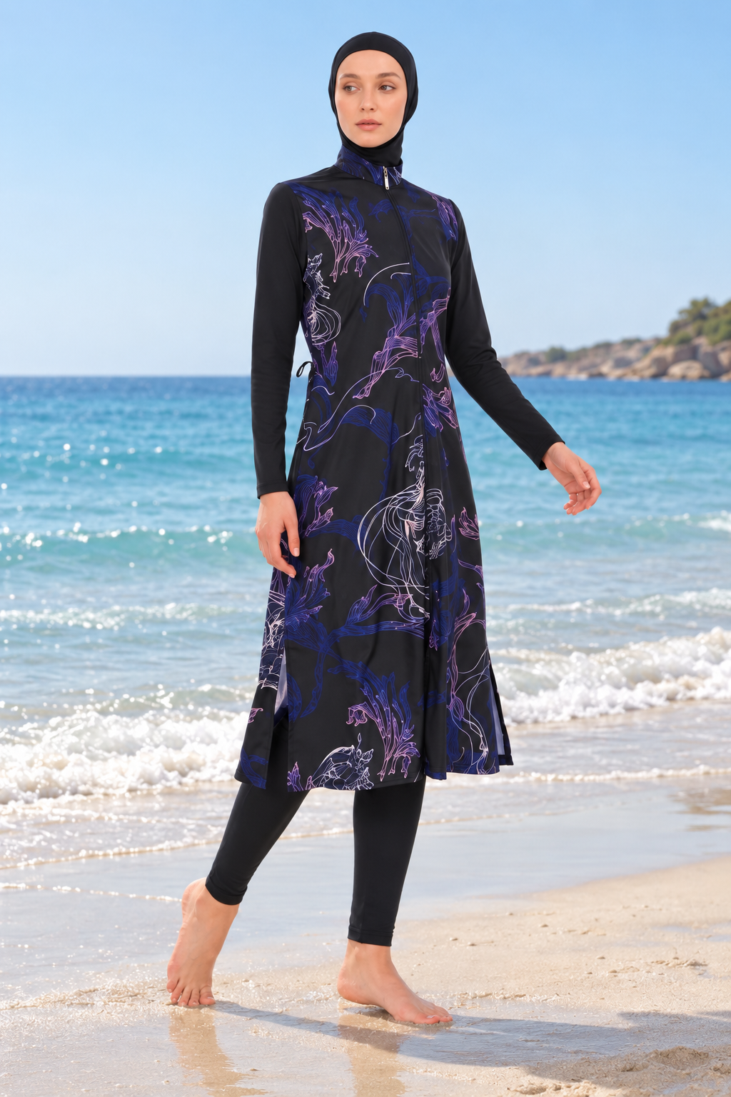 Front view of women's navy floral full-coverage modest swimwear with hijab, long tunic and leggings on beach
